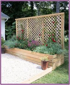 an outdoor garden with flowers and plants growing in the planter boxes on the side