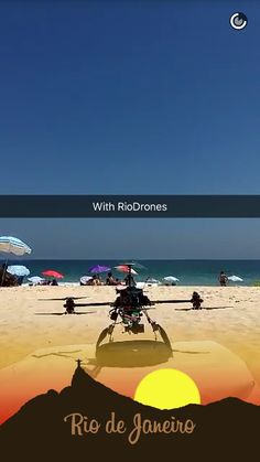 a helicopter is flying over the beach with umbrellas