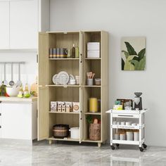 a kitchen with white cabinets and marble flooring