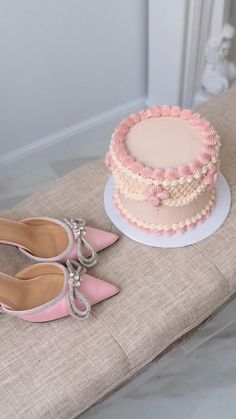 there is a cake and pair of shoes on the table next to eachother