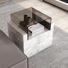 a marble coffee table sitting on top of a gray rug