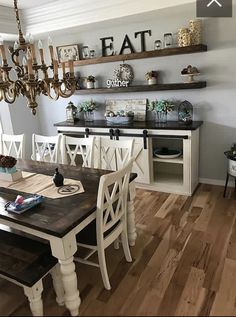 a dining room table with chairs and a chandelier hanging above it on the wall