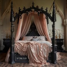 a canopy bed with pink drapes on it's headboard and foot board