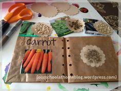 an open book with carrots and paper flowers on it, surrounded by crafting supplies