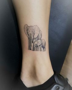 an elephant and her baby tattoo on the ankle