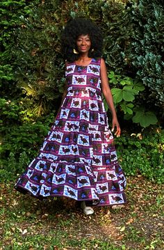 "A gorgeous tiered dress in a contemporary African print in a purple and white with dashes of deep green, blue and fuschia. The dress is tiered and full giving a swish which enhances the way the dress falls on the wearer. Wear with or without a belt. Closure is by a back zip with side pockets. A dress that will take you through the changing seasons. On warmer days wear with sandals or trainers and in cooler weather wear your boots, layer with a skinny long top and throw on your leather jacket or coat.  Partial lining at the upper part of the dress. 100% Cotton. Handmade in Ghana.  length of the dress is 56\"-57\"  Although we do our best to make sure that the colours displayed on our Website are accurate, the actual colours may vary. Differences in monitors and the device you use to view t Purple Fitted Tiered Maxi Dress, Purple Tiered Dress With Floral Print, Purple Tiered Ruffle Hem Dress, Purple Tiered Dress With Ruffle Hem, Weather Wear, Bird Print, Purple And White, Changing Seasons, Tiered Dress