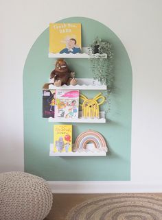 there is a book shelf with books on it and a stuffed animal in the corner