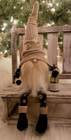 a stuffed gnome sitting on top of a wooden bench