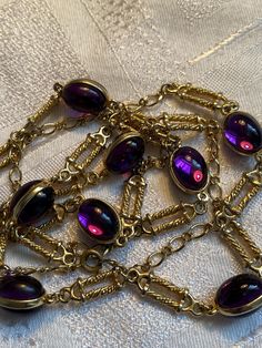 Gorgeous 80's station necklace featuring purple double cabochon links Heavily gold plated  It measures 34 inches in total length  In good condition with little wear to the gold plate  To nice to sit in the drawer 🙂 Chili Board, Station Necklace, Long Chain, Chains Necklace, Favorite Jewelry, Violet, Gold Plate, Jewelry Necklaces, Accessory Gift