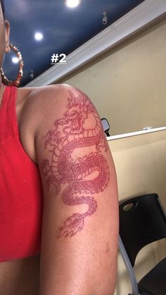 a woman with a dragon tattoo on her arm