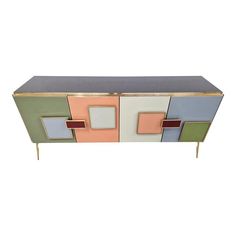 a multicolored sideboard with metal legs