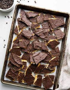 a pan filled with chocolate and peanut butter crackers on top of a white table