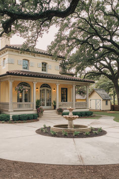 a house with a fountain in front of it