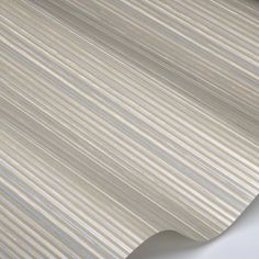 a beige and white wallpaper with vertical stripes on the outside, in an angled pattern