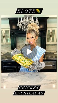 a woman holding a plate with food on it in front of a stove top oven