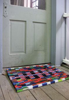 a multicolored rug on the floor in front of a door