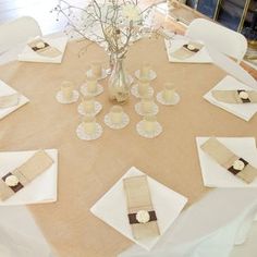 the table is set with place settings and napkins for guests to sit down at