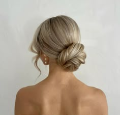 a woman with blonde hair in a low bun