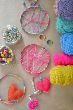 yarn, beads, and other crafting supplies are laid out on the table together