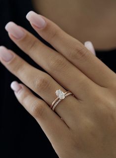 a woman's hand with a diamond ring on it