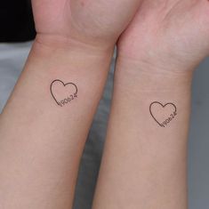 two people with matching tattoos on their arms