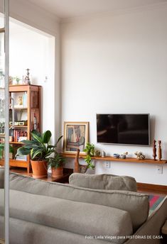 a living room filled with furniture and a flat screen tv