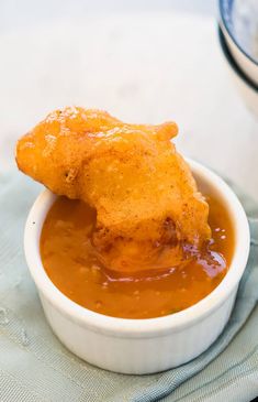 a bowl filled with sauce and fried chicken wings