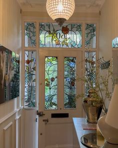 an entryway with stained glass windows and a door leading to the front entrance area