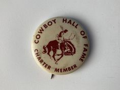 a button with the words cowboy hall of fame on it