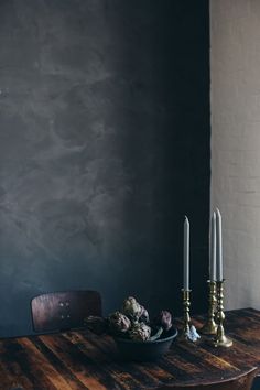 a wooden table with two candles on it