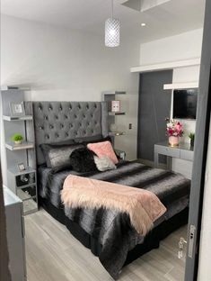 a bedroom with a large bed and grey walls