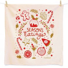 a tea towel hanging on a clothes line with the words season's eatings