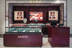 a gucci store display with many items in it