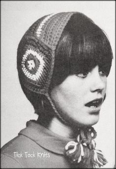 an old photo of a woman wearing a knitted beanie hat with circles on it