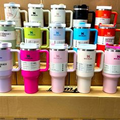 many different colored coffee mugs are on display