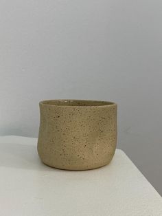 a small bowl sitting on top of a white table