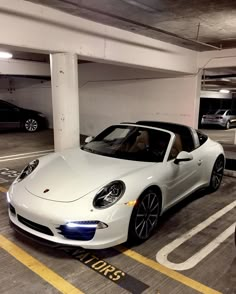 a white sports car parked in a parking garage