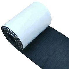 a roll of black and white paper sitting on top of a floor