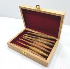 a wooden box filled with lots of wood stick in it's opening and inside