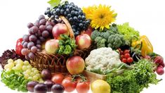 a basket filled with lots of different types of fruits and vegetables next to each other