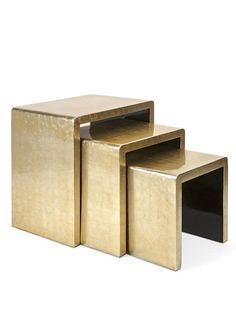 three gold and black square side tables with one sitting on the other's legs