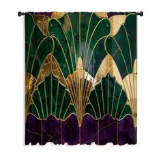 an art deco style wall hanging with green and gold fan shaped designs on it's side