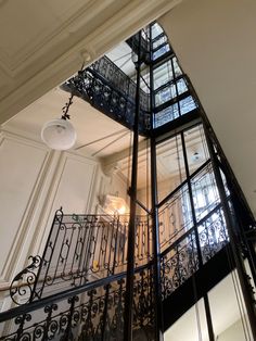 the inside of a building with wrought iron railings and glass balconies on each floor