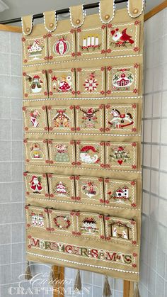 a quilted christmas calendar hanging on the wall