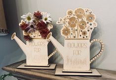 two vases that have flowers in them on a shelf next to each other with the words flowers for mama