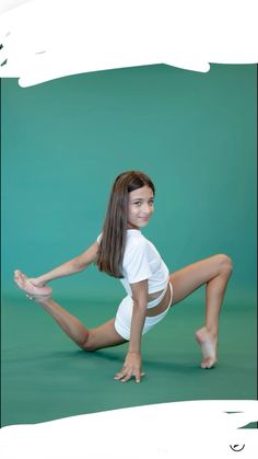 a young woman is posing for a photo in white clothing and heels, with her legs spread out