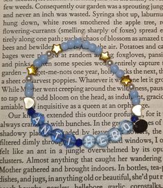 a blue beaded bracelet with gold accents on top of an open page of a book