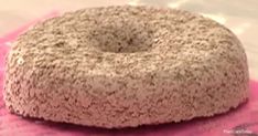 a donut sitting on top of a pink towel