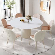 a white table with four chairs around it in a room next to a large window