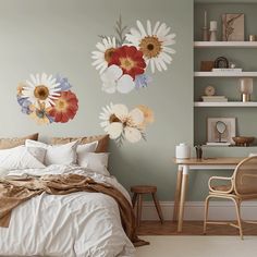 a bedroom with two flower wall decals on the walls and a bed in the foreground